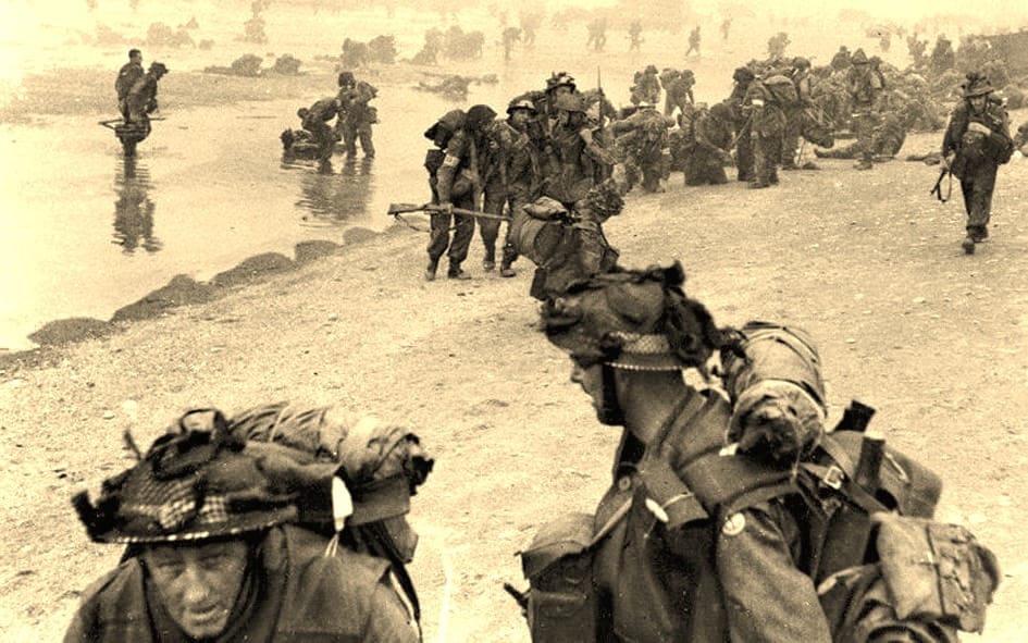 Army soldiers arriving on the beach.